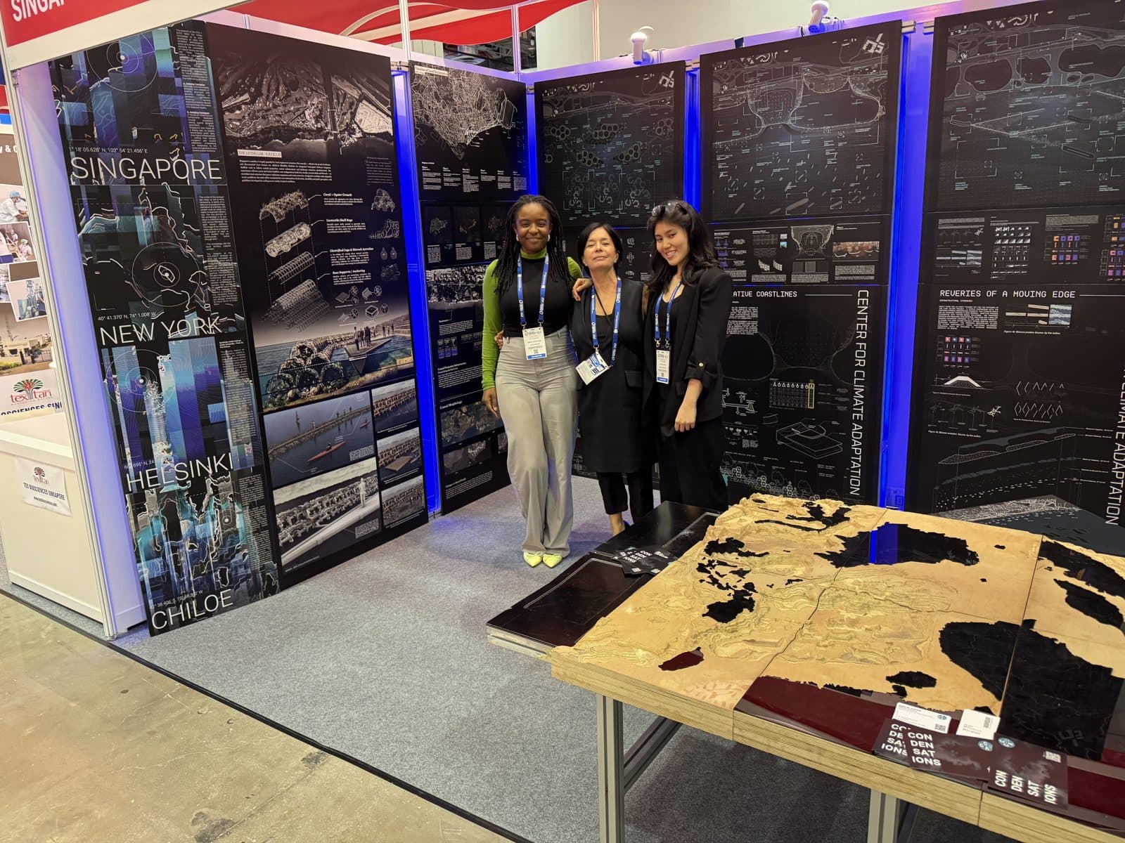 Visitors at the CCA exhibition booth beside the territorial model